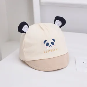Close-up of cotton baby panda cap with soft brim and 3D ears in cream and tan