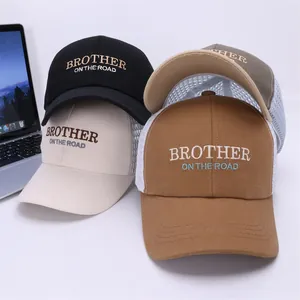 Detail of embroidered trucker hats in four colors with breathable mesh back and letter design