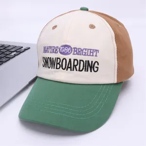 Close-up of vintage patchwork baseball cap with detailed embroidery on a white desk