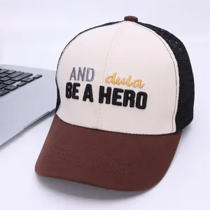 Detailed shot of three-color trucker hat featuring mesh back and 3D 'BE A HERO' embroidery