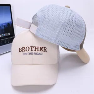 Detailed macro view of mesh trucker caps featuring high-quality embroidery and breathable fabric
