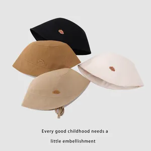 Kids cotton bucket hats in four neutral colors with cute cloud labels for sun protection