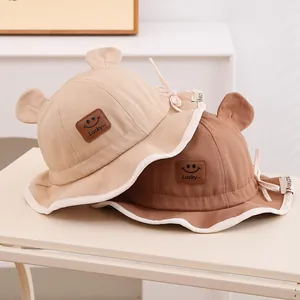 Détail de chapeaux de soleil bébé avec écusson Lucky et jolies oreilles décoratives