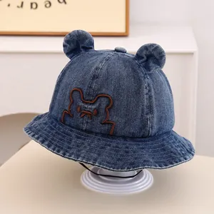 Detail of blue denim baby bucket hat with cute 3D bear ears and chin strap