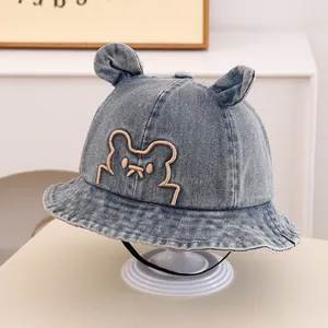 Detailed denim texture on baby bucket hat with bear embroidery and 3D ears