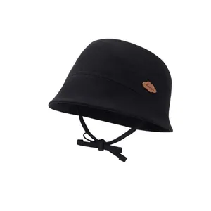 Black knit kids bucket hat with a small leather cloud label and adjustable chin strap