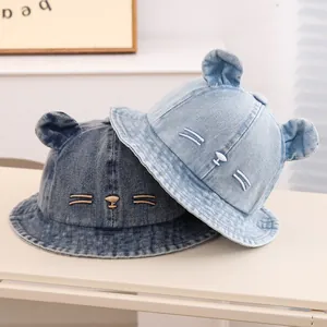 Detail of baby denim bucket hats with 3D animal ears and embroidered bear faces