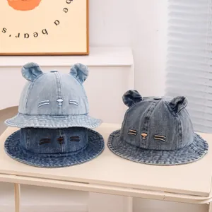 Detailed view of kids denim bucket hats with cute bear ears and cat face embroidery