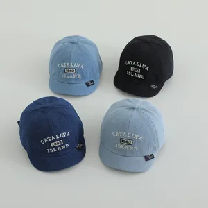 Kids denim baseball caps in four colors featuring Boston embroidered short brims