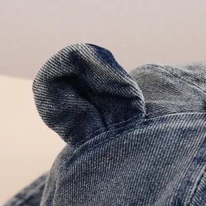 Detailed view of the cute 3D bear ear design and stitching on blue denim baby sun hat