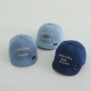 Detailed embroidery texture on toddler denim baseball caps in three shades of blue