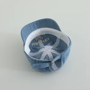 Detailed inner view of kids denim baseball cap showing stitched seams and adjustable buckle