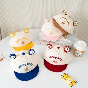Close-up of five colorful baby bear caps with happy baby embroidery and soft ears
