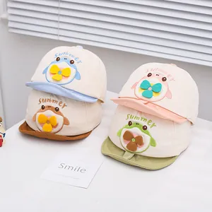 Detail of four colorful baby sun hats with cartoon animal patterns and summer embroidery