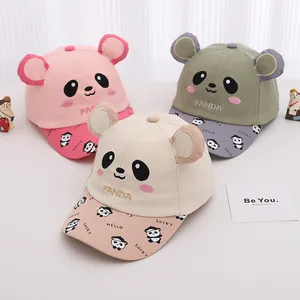 Detail of pink, green and beige kids' panda baseball caps with 3D ears and embroidery