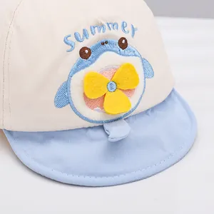 Baby baseball cap with cartoon shark embroidery and a yellow propeller detail in beige