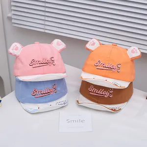 Detail view of cotton baby baseball caps with smiley embroidery and cute 3D soft ears