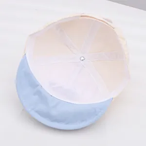 Detail view of baby sun hat showing breathable white mesh lining and soft blue brim