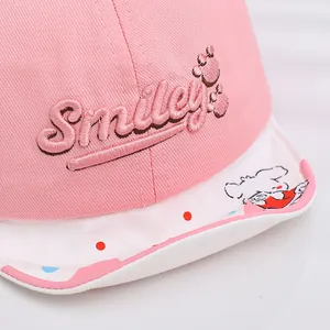 Pink cotton baseball cap for babies with Smiley embroidery and cute polka dot dog brim