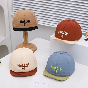 Collection of baby baseball caps in khaki, red, cream and blue with Hello embroidery