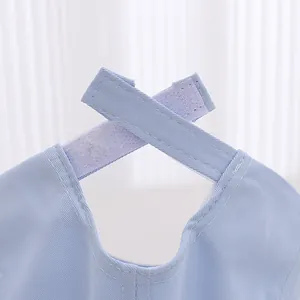 Detail of adjustable criss-cross velcro strap on light blue cotton baseball cap