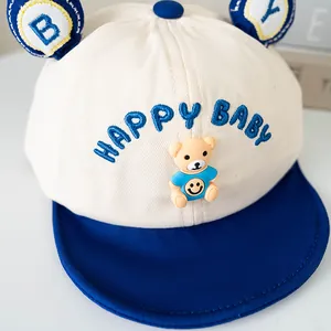 Cream baby baseball cap with blue bear doll and Happy Baby embroidery for toddlers