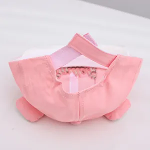 Detail view of pink baby baseball cap showing adjustable velcro strap and cute ear design