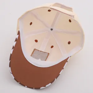Close-up of kids baseball cap interior showing plaid brim detail and reinforced stitching