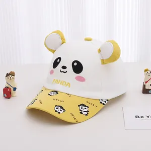 Detail of baby baseball cap featuring cartoon panda ears and printed yellow brim