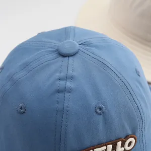 Close-up of blue cotton baseball cap with 3D letter embroidery and premium stitching