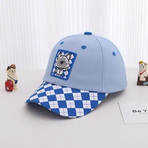 Detail of light blue baby baseball cap with checkered brim and cute puppy embroidery