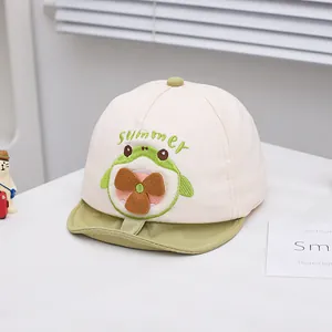 Detail of baby baseball cap with green frog embroidery and interactive fan decoration