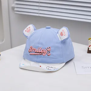 Close-up of light blue baby baseball cap with 3D animal ears and Smiley embroidery detail