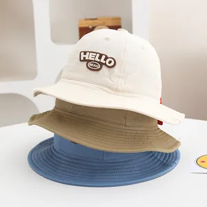 Detail of baby corduroy bucket hats with HELLO embroidery in beige, khaki and blue