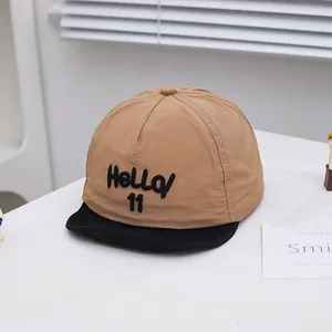 Detail of baby baseball cap with Hello 11 embroidery and stylish khaki-black contrast