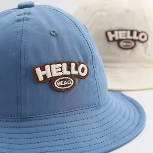 Classic cotton bucket hat for girls with Hello embroidery in blue and beige colors