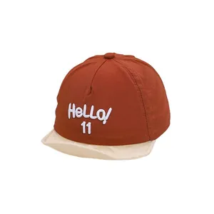 Kids baseball cap in brick red and cream with Hello 11 embroidery on white background