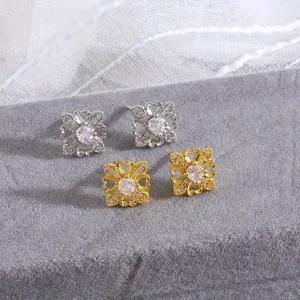 Elegant gold and silver four-leaf clover stud earrings set with sparkling zircon crystals