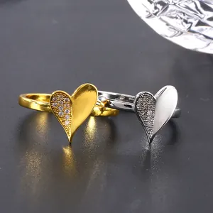 Elegant gold and silver heart rings with micro-pave cubic zirconia on dark background