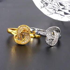 Elegant gold and silver intertwined swirl rings with micro-set cubic zirconia accents