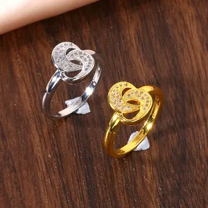 Macro view of gold and silver interlocking ring set with micro-paved cubic zirconia