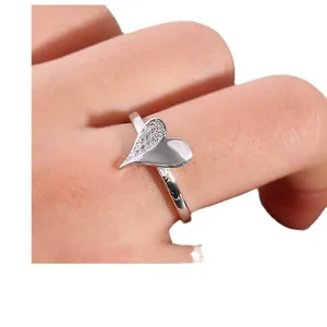 Micro shot of asymmetric heart ring with cubic zirconia micro-pave and silver polished finish