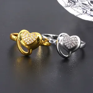 Luxe gold and silver heart rings with micro-set zircons on dark textured surface