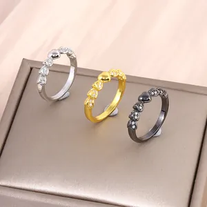 Three elegant heart-shaped rings in gold, silver, and black finish with cubic zirconia