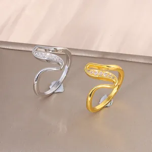 Elegant gold and silver wave-shaped rings with sparkling zircon pavé setting