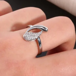 Infinity drop cubic zirconia copper ring with asymmetric streamlined leaf design on hand