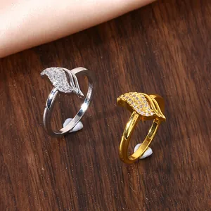 Detail of infinity leaf rings in gold and silver finish with pavé set cubic zirconia