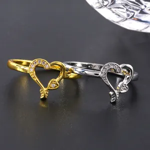 Anelli a doppio cuore in oro e argento con micro-pavé di zirconi rosa e trasparenti