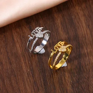 Macro detail of LOVE heart ring with micro-paved cubic zirconia in gold and silver