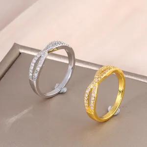 Infinity crossover ring in gold and silver finish with micro-pave cubic zirconia stones